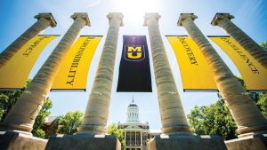 Banners displaying Mizzou's core values hang between the Columns in front of Jesse Hall.