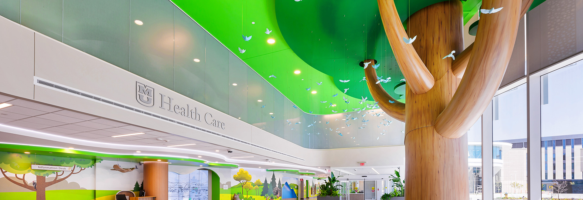Glass bluebirds hang suspended beneath the canopy of a two-story tree sculpture inside the lobby of MU Health Care's Children's Hospital